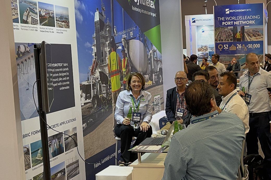 Heather Heydet in conversation with customers at a Synthetex trade show stand